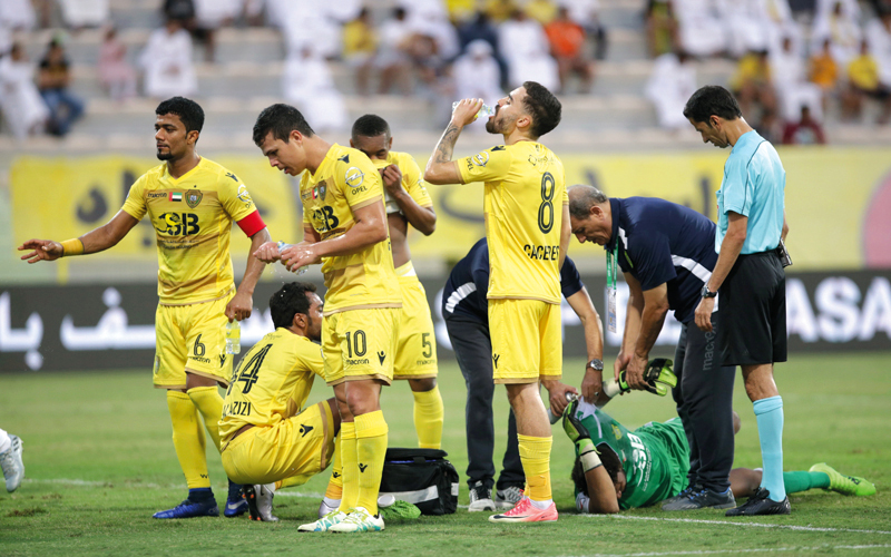 لاعبو الوصل استغلوا توقف المباراة لعلاج زميلهم الحارس سلطان المنذري، في شرب المياه، خلال مواجهة عجمان. تصوير: مصطفى قاسمي